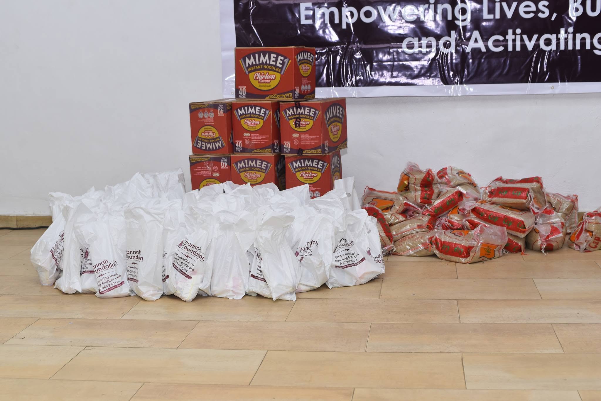 Essential food supplies, including bags of rice and packaged instant noodles, gathered by the Prayer of Hannah Foundation for community welfare and outreach distribution